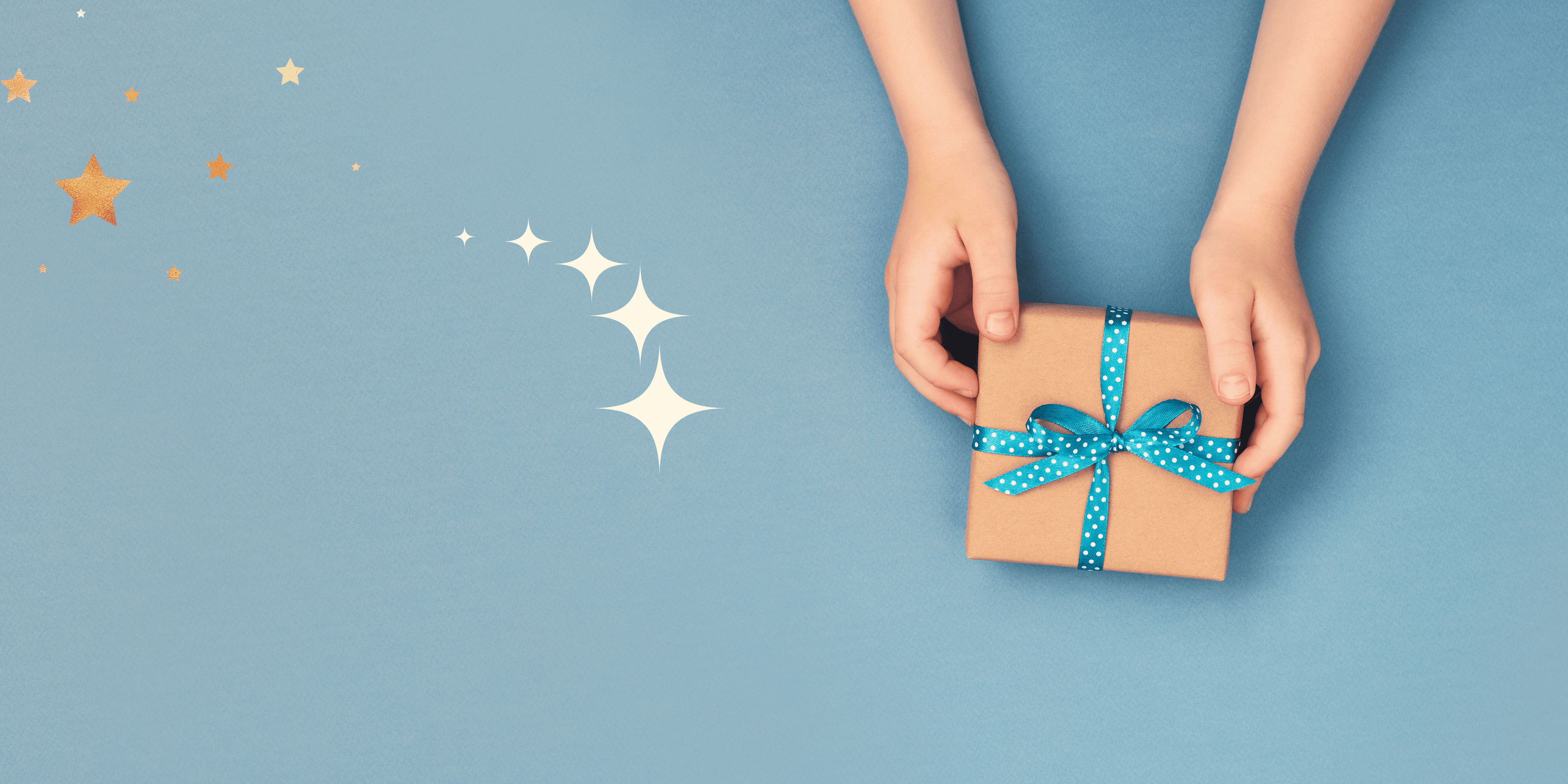 Hands holding a small gift box with a blue ribbon on a light blue background with stars.